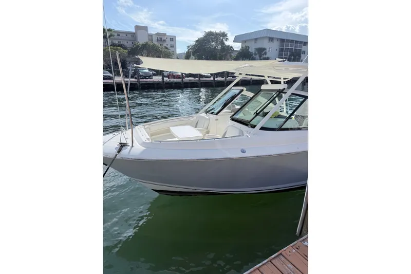  Yacht Photos Pics 2022 Pursuit DC 266 Dual Console boat docked by the water.