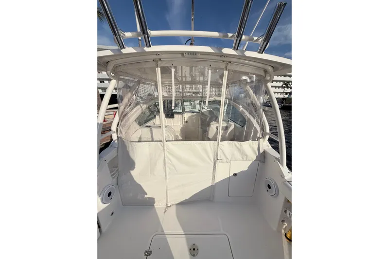  Yacht Photos Pics 2022 Pursuit DC 266 Dual Console boat with clear enclosure and white interior.