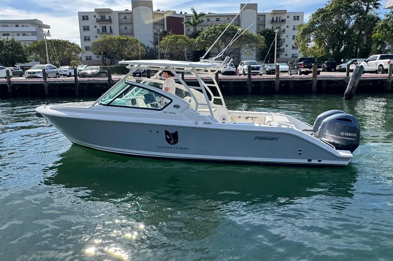  Yacht Photos Pics 2022 Pursuit DC 266 Dual Console boat on water, with Yamaha engine, near urban waterfront.