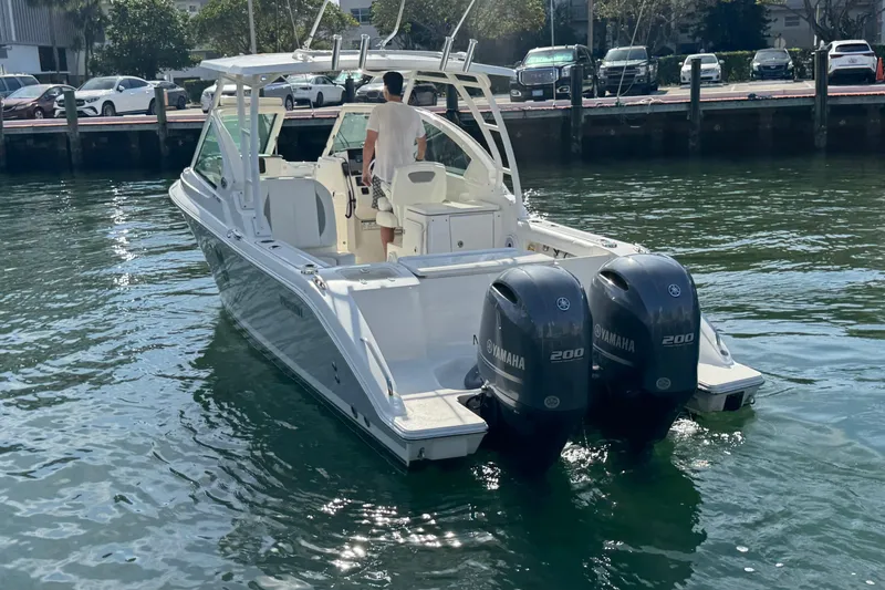 Yacht Photos Pics 2022 Pursuit DC 266 Dual Console boat with twin Yamaha 200 engines on water.