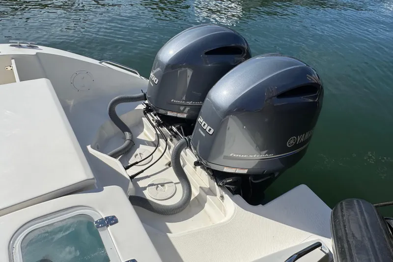  Yacht Photos Pics 2022 Pursuit DC 266 Dual Console with twin Yamaha outboard engines on water.