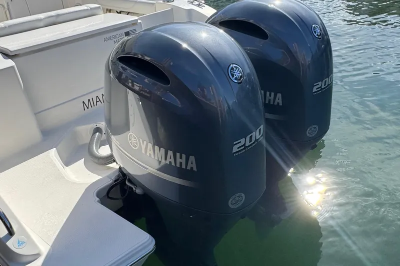  Yacht Photos Pics 2022 Pursuit DC 266 Dual Console with twin Yamaha 200 engines in water.