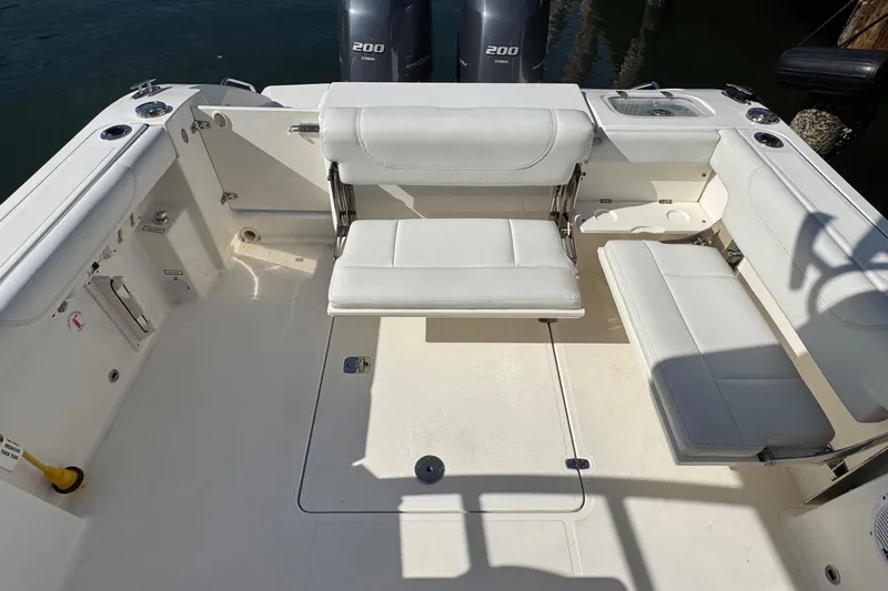  Yacht Photos Pics 2022 Pursuit DC 266 Dual Console boat interior with white seating and twin engines.