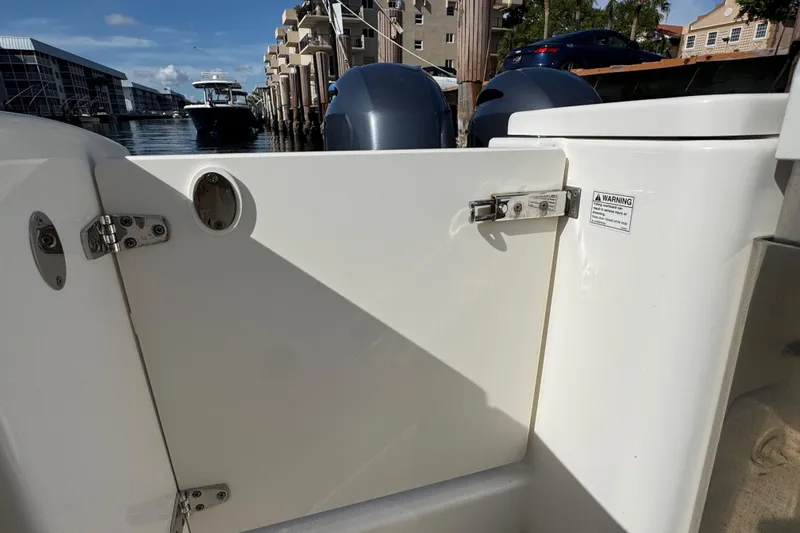  Yacht Photos Pics 2022 Pursuit DC 266 Dual Console boat interior with docked marina view.