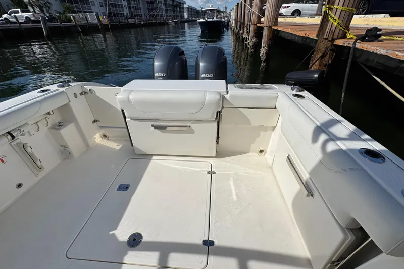  Yacht Photos Pics 2022 Pursuit DC 266 Dual Console boat interior with twin 200 engines, docked by the water.