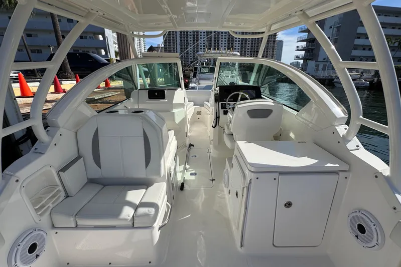  Yacht Photos Pics 2022 Pursuit DC 266 Dual Console boat interior with seating and helm, docked in a marina.