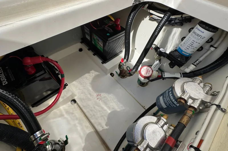 Yacht Photos Pics 2022 Pursuit DC 266 Dual Console engine compartment with batteries and fuel filters.