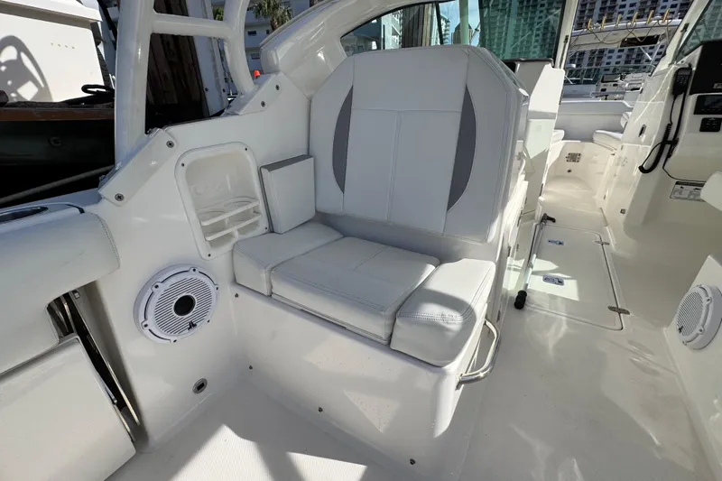  Yacht Photos Pics 2022 Pursuit DC 266 Dual Console boat interior with white seating and speaker.