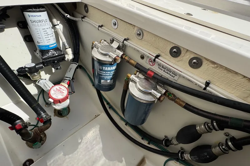  Yacht Photos Pics 2022 Pursuit DC 266 Dual Console boat engine compartment with fuel and water systems.