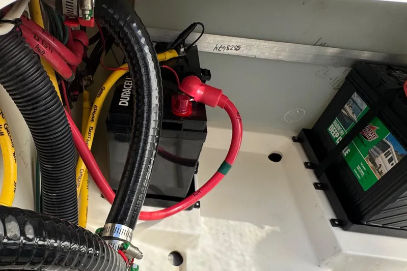  Yacht Photos Pics Battery compartment of 2022 Pursuit DC 266 Dual Console boat with cables and connections.