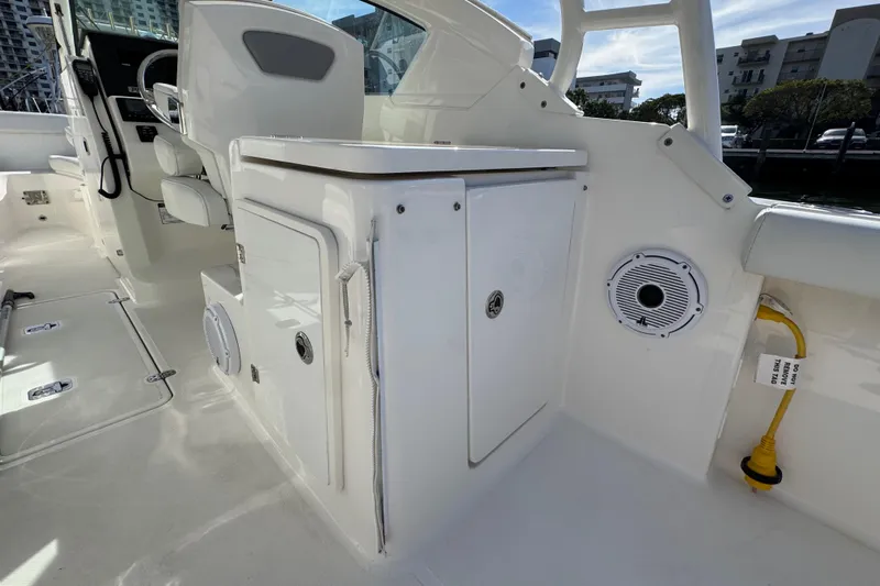  Yacht Photos Pics 2022 Pursuit DC 266 Dual Console interior with seating and storage compartments.
