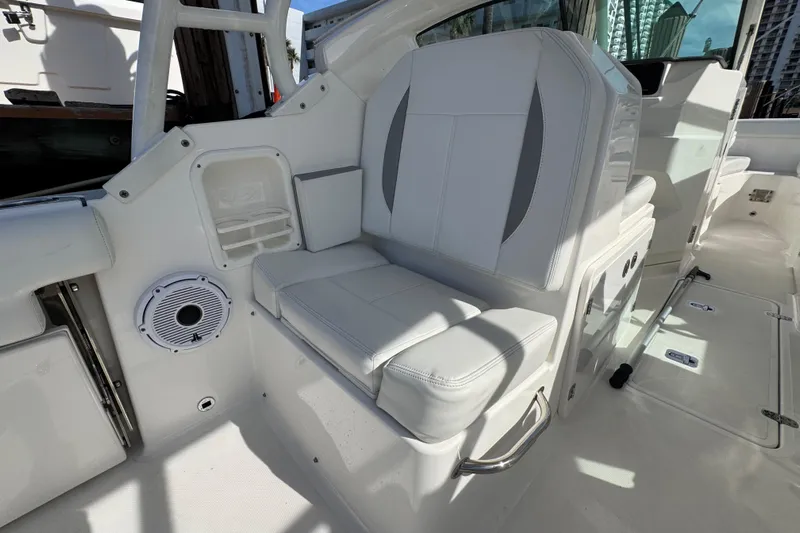  Yacht Photos Pics 2022 Pursuit DC 266 Dual Console boat interior with white seating and speaker.
