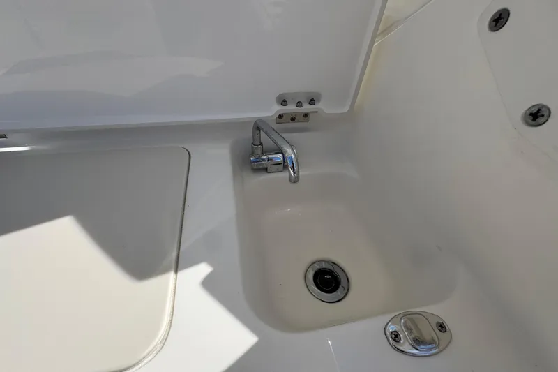  Yacht Photos Pics 2022 Pursuit DC 266 Dual Console boat sink with chrome faucet.