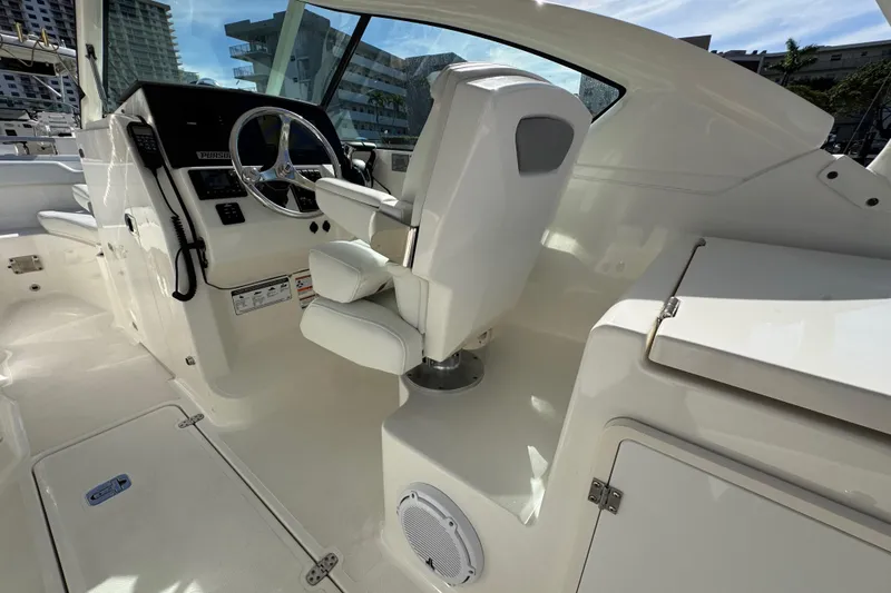  Yacht Photos Pics 2022 Pursuit DC 266 Dual Console boat interior with steering wheel and seating.