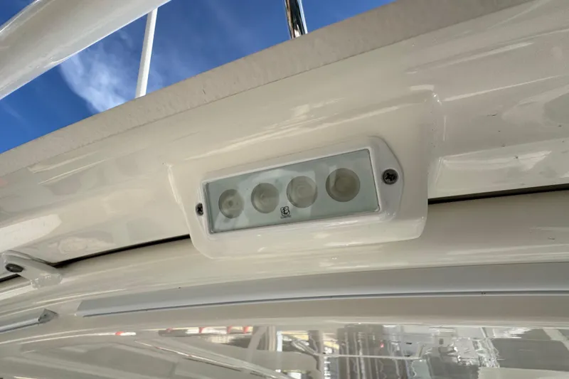  Yacht Photos Pics LED light fixture on 2022 Pursuit DC 266 Dual Console boat, under clear blue sky.