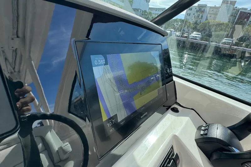  Yacht Photos Pics 2022 Pursuit DC 266 Dual Console boat dashboard with Garmin navigation display.