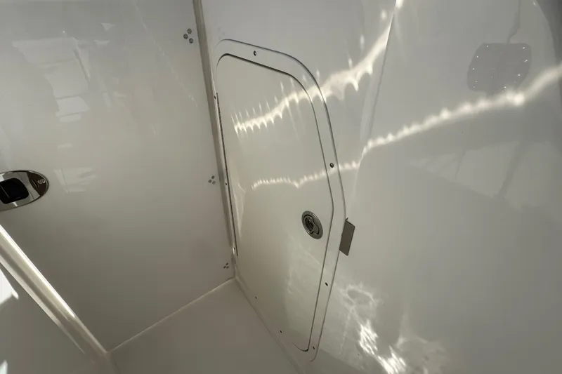  Yacht Photos Pics 2022 Pursuit DC 266 Dual Console interior compartment with sleek white finish.