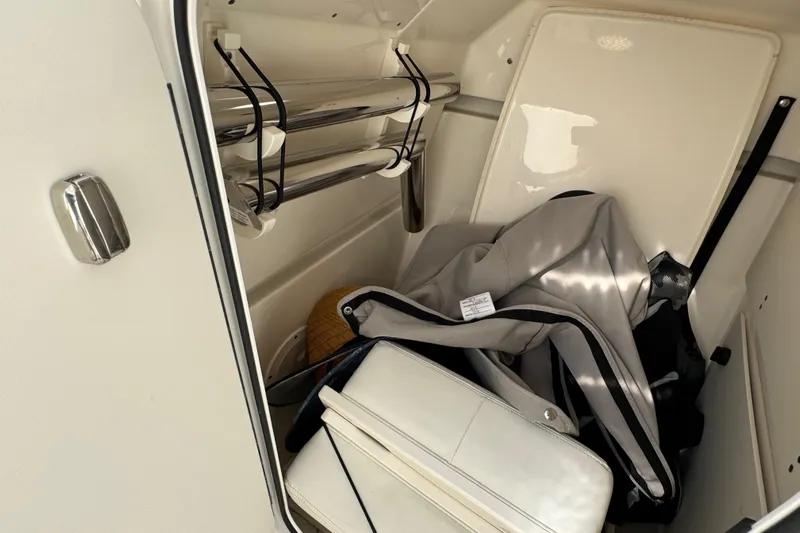  Yacht Photos Pics Storage compartment in 2022 Pursuit DC 266 Dual Console boat with gear and accessories.