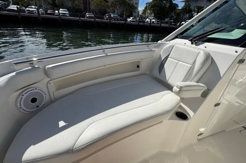  Yacht Photos Pics 2022 Pursuit DC 266 Dual Console boat interior with white seating and waterfront view.