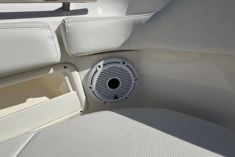  Yacht Photos Pics 2022 Pursuit DC 266 Dual Console boat interior with speaker and cushioned seating.