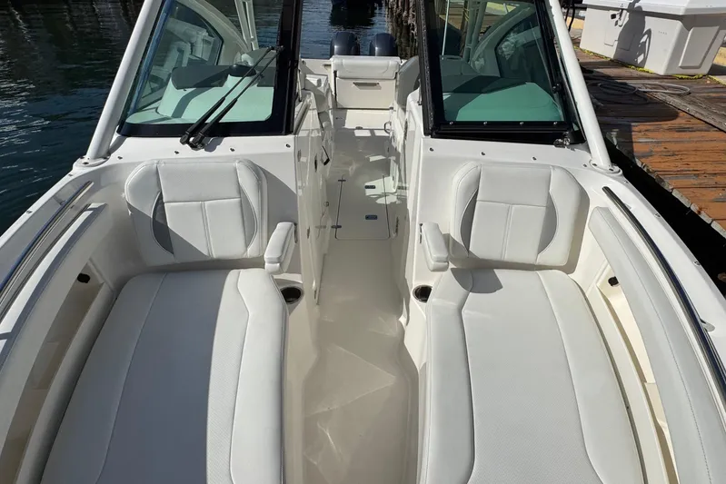  Yacht Photos Pics 2022 Pursuit DC 266 Dual Console boat interior with white seating and open deck.