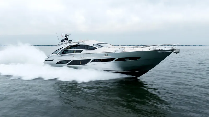 Stallion Yacht Photos Pics 2022 Pershing 9X yacht speeding on open water, showcasing sleek design and performance.