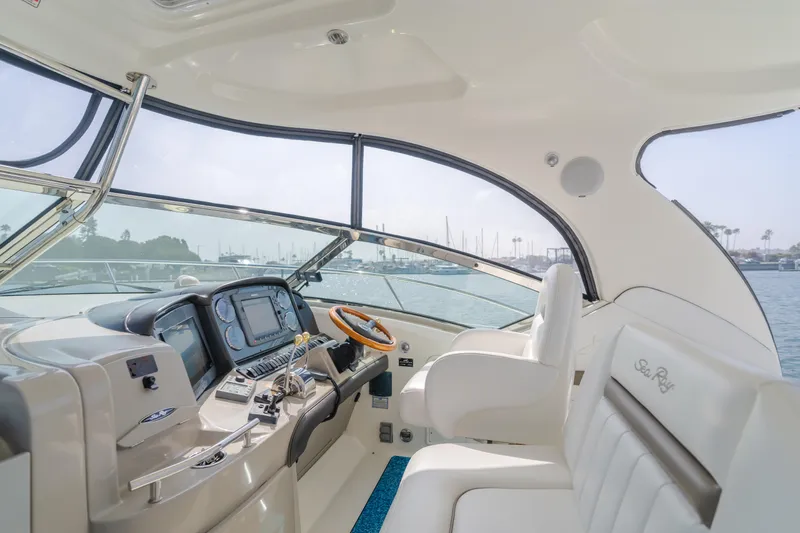 Sea-rinity Yacht Photos Pics Interior cockpit of a 2007 Sea Ray 40 Sundancer yacht with modern navigation equipment.