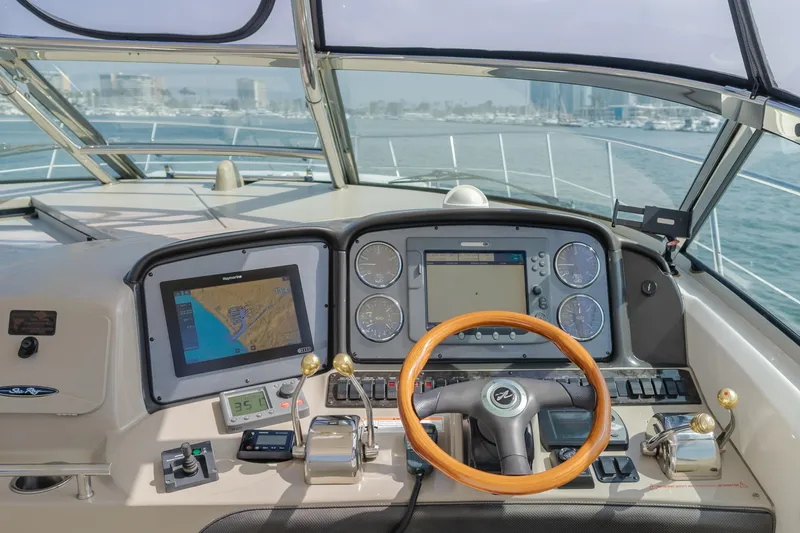 Sea-rinity Yacht Photos Pics Helm of 2007 Sea Ray 40 Sundancer with navigation screens and steering wheel.