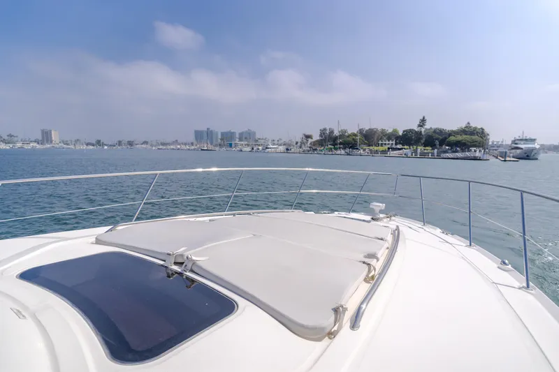 Sea-rinity Yacht Photos Pics Front deck view of a 2007 Sea Ray 40 Sundancer yacht cruising in a harbor.