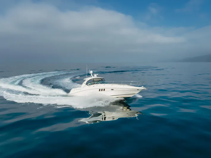 Sea-rinity Yacht Photos Pics 2007 Sea Ray 40 Sundancer cruising on open water under a clear sky.