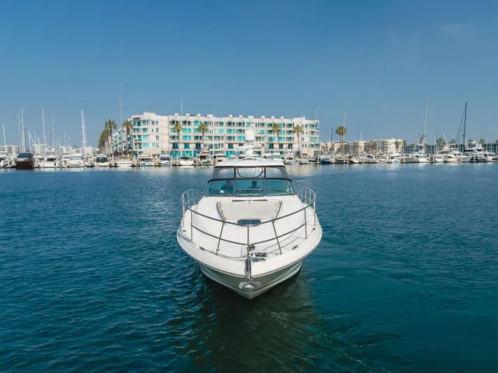 Sea-rinity Yacht Photos Pics 2007 Sea Ray 40 Sundancer yacht in a marina with waterfront buildings.