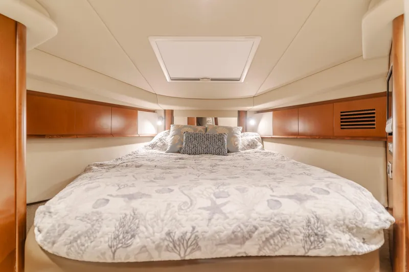 Sea-rinity Yacht Photos Pics Luxurious bedroom interior of 2007 Sea Ray 40 Sundancer yacht with cozy bedding.