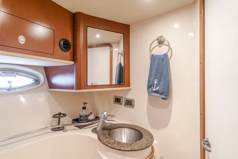 Sea-rinity Yacht Photos Pics 2007 Sea Ray 40 Sundancer bathroom with sink, mirror, and towel.