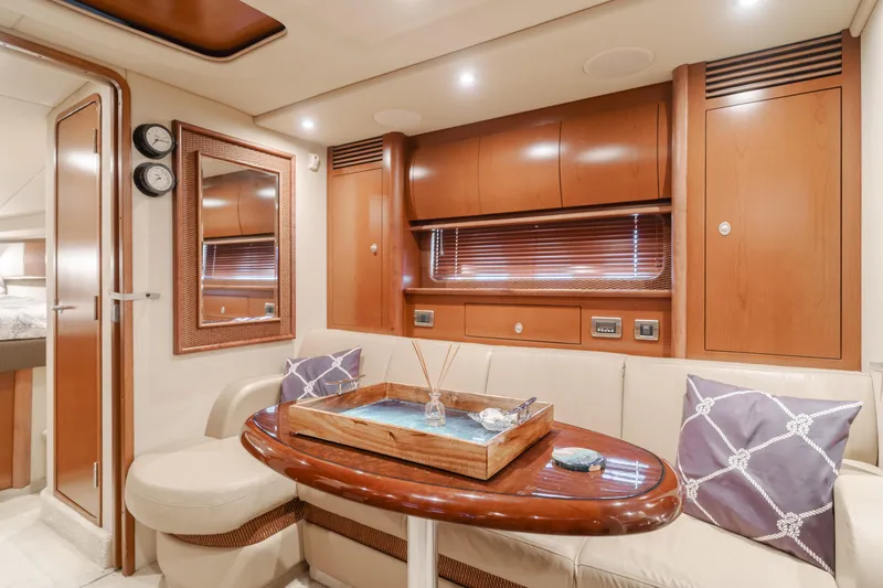 Sea-rinity Yacht Photos Pics Luxurious interior of 2007 Sea Ray 40 Sundancer yacht with wooden cabinetry and cozy seating.