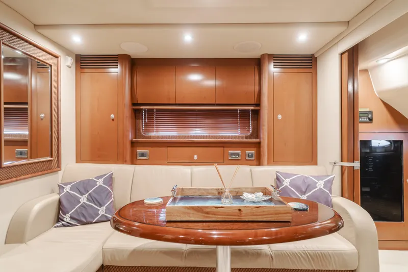 Sea-rinity Yacht Photos Pics Luxurious interior of 2007 Sea Ray 40 Sundancer yacht with wooden cabinetry and plush seating.