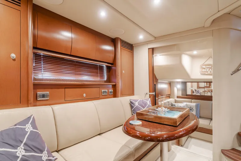 Sea-rinity Yacht Photos Pics Luxurious interior of 2007 Sea Ray 40 Sundancer yacht with beige seating and wooden accents.
