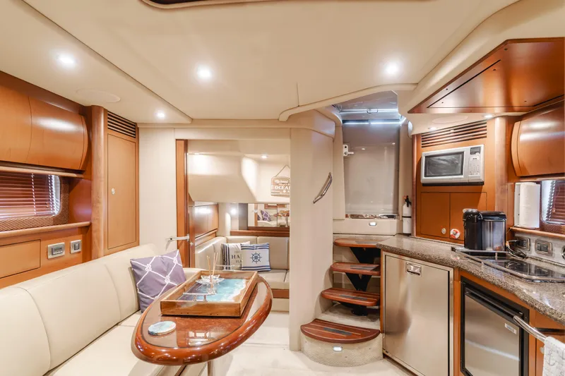 Sea-rinity Yacht Photos Pics Luxurious interior of 2007 Sea Ray 40 Sundancer yacht with modern kitchen and cozy seating area.