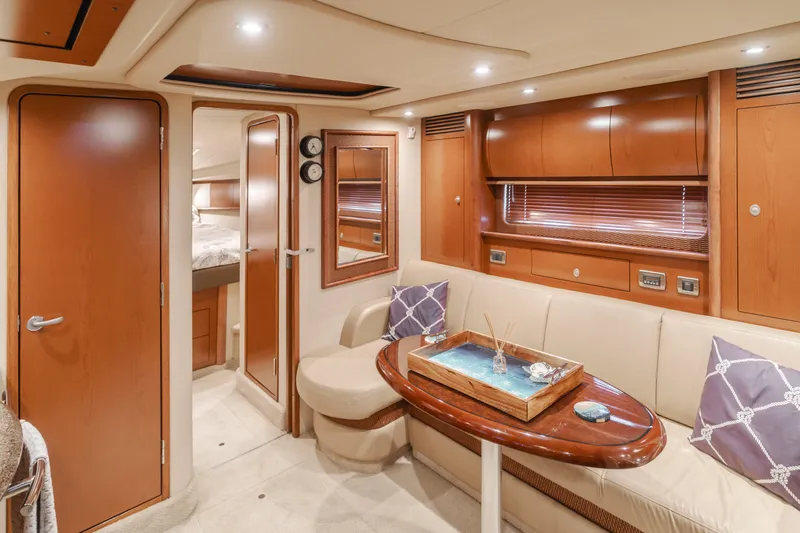 Sea-rinity Yacht Photos Pics Luxurious interior of a 2007 Sea Ray 40 Sundancer yacht with wooden cabinetry and cozy seating.