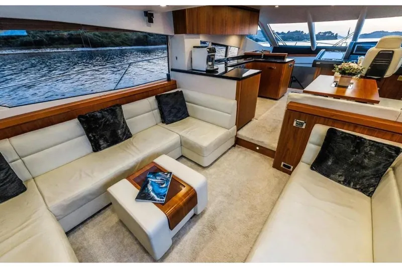 2 Drunk Yacht Photos Pics Luxurious interior of 2012 Sunseeker Manhattan 63 yacht with elegant seating and modern design.