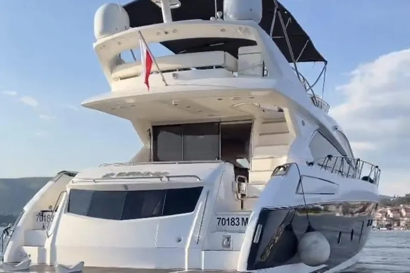 2 Drunk Yacht Photos Pics Luxurious 2012 Sunseeker Manhattan 63 yacht on serene waters, rear view.