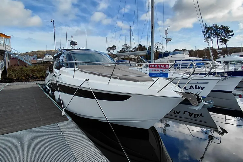 Huge Specifications Yacht Photos Pics 2023 Galeon 405 HTS yacht docked, for sale, under a partly cloudy sky.