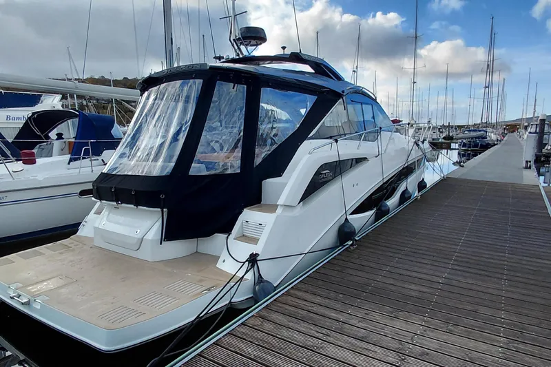 Huge Specifications Yacht Photos Pics 2023 Galeon 405 HTS yacht docked at marina under cloudy sky.