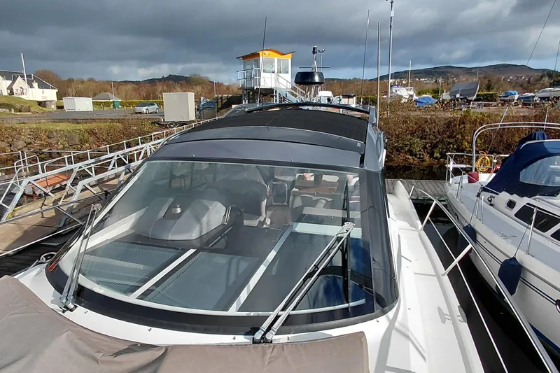 Huge Specifications Yacht Photos Pics 2023 Galeon 405 HTS yacht docked at a marina under cloudy skies.