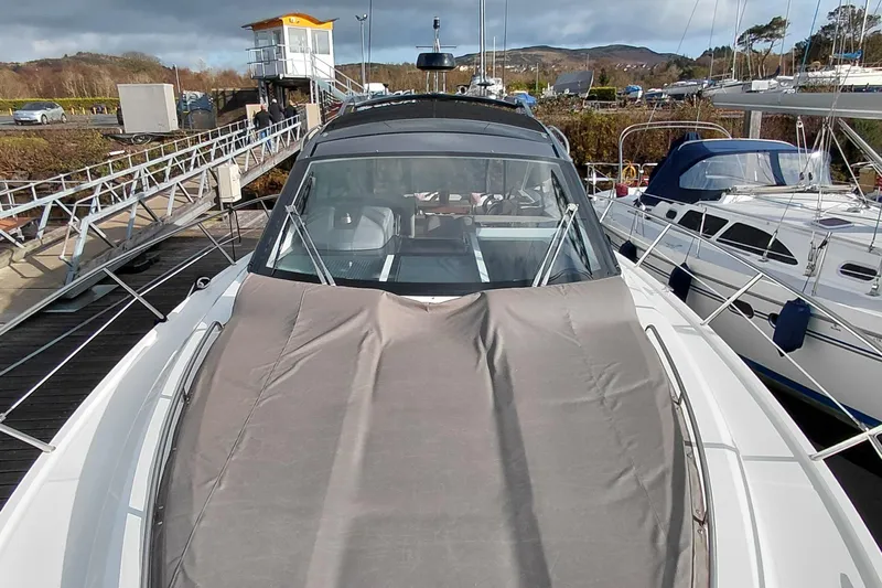 Huge Specifications Yacht Photos Pics 2023 Galeon 405 HTS yacht docked at marina, covered deck, surrounded by other boats.