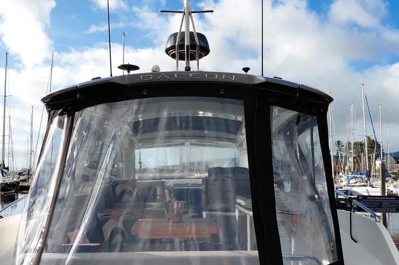 Huge Specifications Yacht Photos Pics 2023 Galeon 405 HTS yacht with clear enclosure, docked at marina.