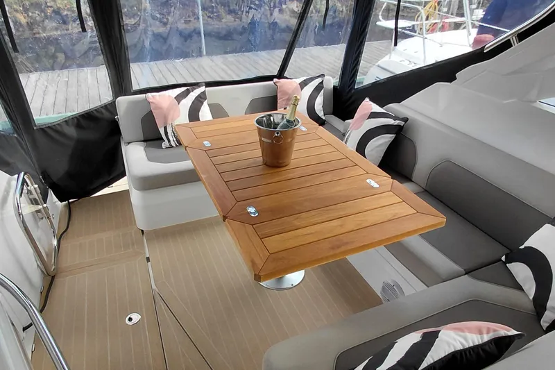 Huge Specifications Yacht Photos Pics Luxurious interior of 2023 Galeon 405 HTS yacht with wooden table and seating.