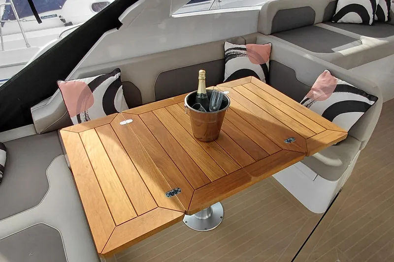 Huge Specifications Yacht Photos Pics Luxurious interior of 2023 Galeon 405 HTS yacht with wooden table and champagne.