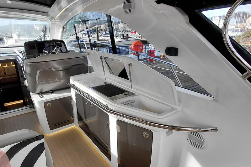 Huge Specifications Yacht Photos Pics Interior of 2023 Galeon 405 HTS yacht with modern helm and kitchenette.