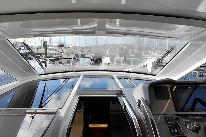 Huge Specifications Yacht Photos Pics Interior view of 2023 Galeon 405 HTS yacht with marina in background.