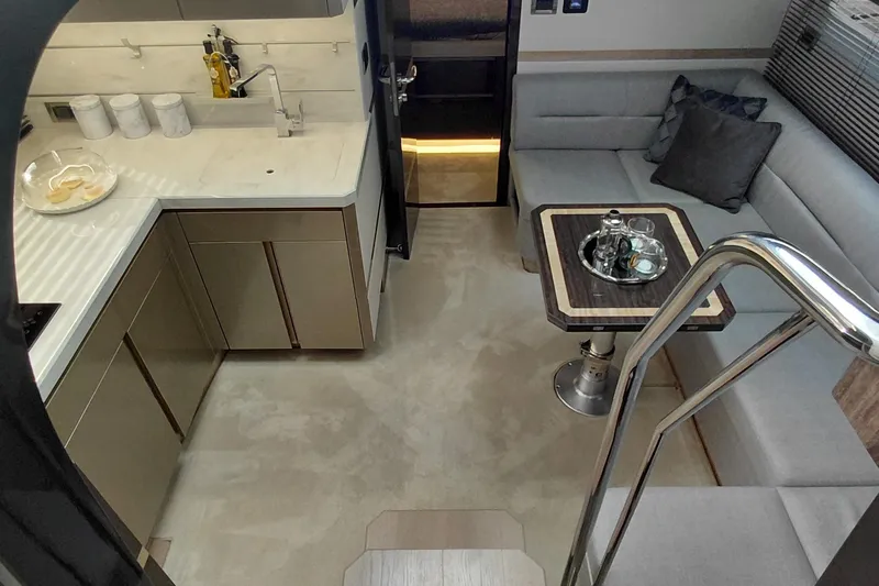 Huge Specifications Yacht Photos Pics Luxurious interior of 2023 Galeon 405 HTS yacht with modern kitchen and cozy seating area.